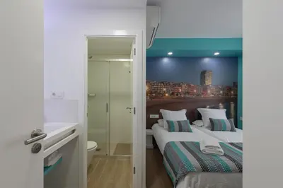 Cama o camas de una habitación en Petit Accommodation Las Canteras Deuxième
