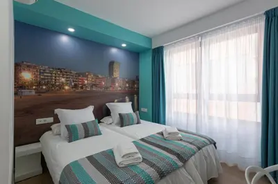 Cama o camas de una habitación en Petit Accommodation Las Canteras Deuxième