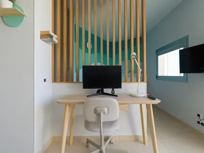 Una televisión o centro de entretenimiento en Living Las Canteras Homes - SMART BEACHFRONT